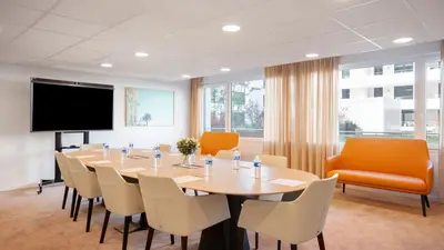 a conference room with a large table and chairs at Residhome Nice Aéroport in Nice