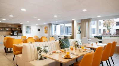 a dining room with tables and chairs in a restaurant at Residhome Nice Aéroport in Nice
