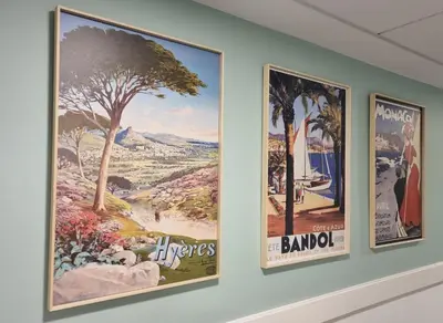 a group of posters hanging on a wall at Residhome Nice Aéroport in Nice