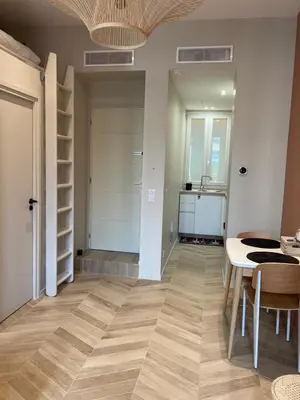 a living room with a table and a kitchen at A & K luxury appartments Port de Nice Garibaldi in Nice