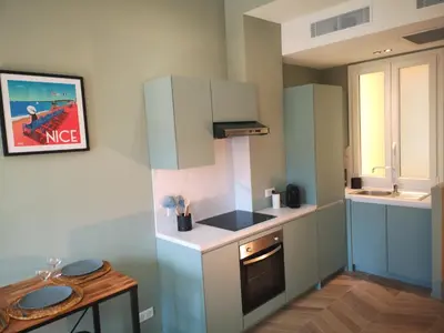 a small kitchen with white and blue cabinets at A & K luxury appartments Port de Nice Garibaldi in Nice