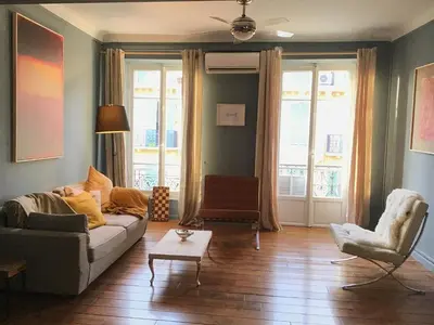 a living room with a couch and two chairs at Modern, traditional , bright and stylish appartement in Nice