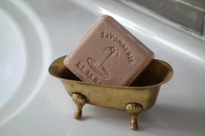 a chocolate bar in a gold bowl on a plate at Modern, traditional , bright and stylish appartement in Nice