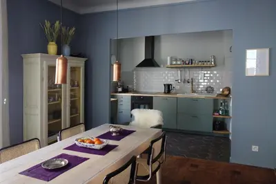 a kitchen with a table with a bowl of fruit on it at Modern, traditional , bright and stylish appartement in Nice