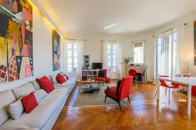 a living room with a couch and a table at Victor Hugo Palais AP3061 by Riviera Holiday Homes in Nice