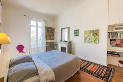 a bedroom with a bed and a desk and a fireplace at Victor Hugo Palais AP3061 by Riviera Holiday Homes in Nice