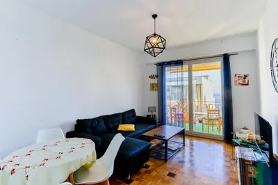 a living room with a couch and a table at Le Béryl in Nice