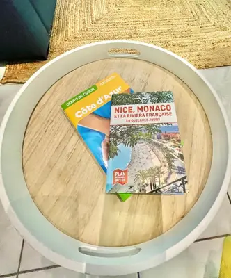 a table with two pamphlets on top of it at Joli appartement spacieux à 3 min à pied de la mer in Nice