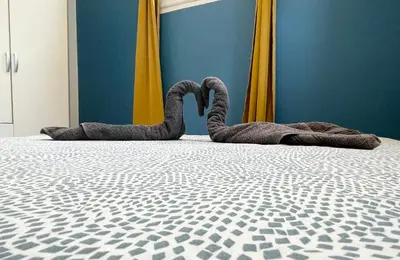 two snakes laying on a bed in a room at Joli appartement spacieux à 3 min à pied de la mer in Nice