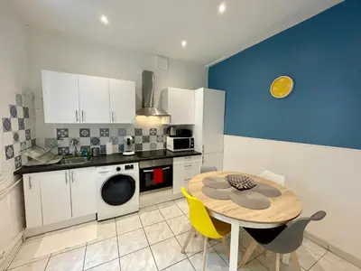 a kitchen with a table and a kitchen with blue at Joli appartement spacieux à 3 min à pied de la mer in Nice