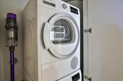 a white washing machine sitting next to a door at Sublime Appartement Promenade des Anglais RDJ in Nice