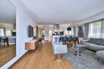 a living room and kitchen with a couch and a table at Sublime Appartement Promenade des Anglais RDJ in Nice