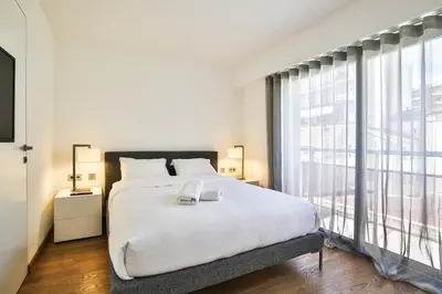 a bedroom with a large bed and a large window at Sublime Appartement Promenade des Anglais (2) in Nice