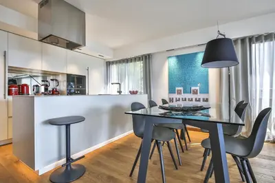 a kitchen and dining room with a table and chairs at Sublime Appartement Promenade des Anglais (3) in Nice