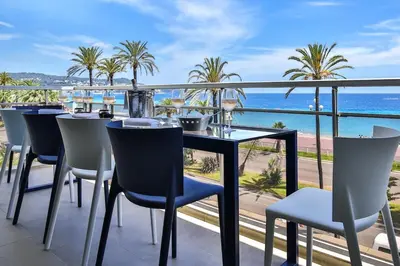 a dining room with a view of the ocean at Sublime Appartement Promenade des Anglais (3) in Nice