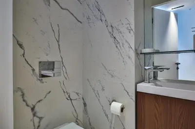 a bathroom with a sink and a marble wall at Sublime Appartement Promenade des Anglais (3) in Nice