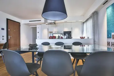 a dining room with a glass table and chairs at Sublime Appartement Promenade des Anglais (3) in Nice
