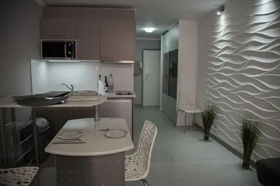 a kitchen with a table and chairs in a room at Stylish Studio in only 50 meters from beach ! in Nice