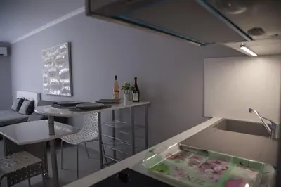 a kitchen with a sink and a table in a room at Stylish Studio in only 50 meters from beach ! in Nice