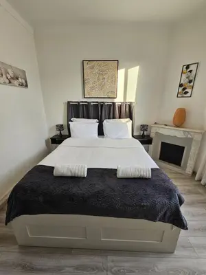 a bedroom with a large bed with two pillows on it at 4 logements à La Trinité proche de Nice 15 mn, Monaco 20 mn et l'Italie 30 mn 2 Chambres et 2 Studios privés et indépendants in La Trinité