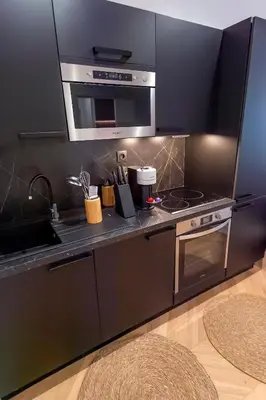 a kitchen with a stove and a microwave at Superbe 2P Plage/ Promenade des Anglais 201 in Nice