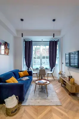 a living room with a blue couch and a table at Superbe 2P Plage/ Promenade des Anglais 201 in Nice