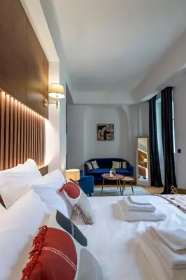 a hotel room with a bed and a couch at Superbe 2P Plage/ Promenade des Anglais 203 in Nice