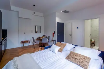 a bedroom with a large white bed and a table at Superbe 2P Plage/ Promenade des Anglais 203 in Nice
