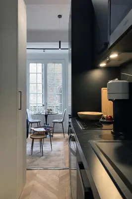 a kitchen with a table and a dining room at Superbe studio Plage/ Promenade des Anglais 102 in Nice