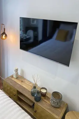 a mirror on a wall above a dresser in a bedroom at Superbe studio Plage/ Promenade des Anglais 102 in Nice