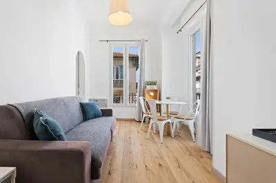a living room with a couch and a flat screen tv at Nice Renting - NOTRE DAME - Cosy Loft Perfect View on the roofs in Nice