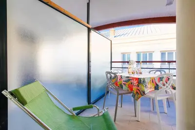 a balcony with a table and chairs on a balcony at PALAIS LIBERTE 4 AP4253 By Riviera Holiday Homes in Nice