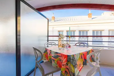 a table and chairs on a balcony with a view at PALAIS LIBERTE 4 AP4253 By Riviera Holiday Homes in Nice