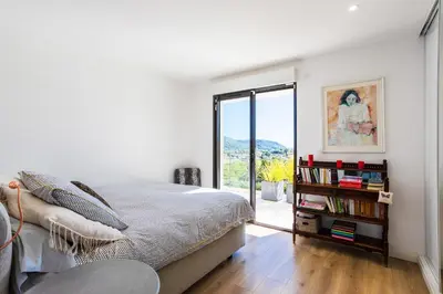 a bedroom with a bed and a book shelf with books at Villa Les Sources VI4245 By Riviera Holiday Homes in Nice