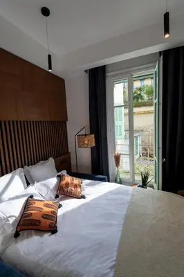 a bedroom with a large bed with two pillows on it at Superbe studio Plage/Promenade des Anglais 105 in Nice
