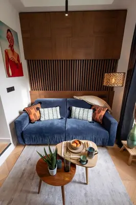 a living room with a blue couch and a table at Superbe studio Plage/Promenade des Anglais 105 in Nice