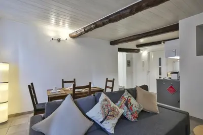 a living room with a blue couch with pillows at Jolie 2 pièces quartier Bonaparte/ Clim in Nice