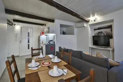 a living room with a table and a couch at Jolie 2 pièces quartier Bonaparte/ Clim in Nice