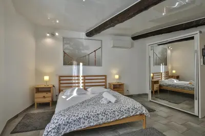 a bedroom with a bed and a large mirror at Jolie 2 pièces quartier Bonaparte/ Clim in Nice