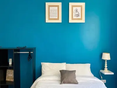 a blue bedroom with a bed with a blue wall at Budget studio Berlioz in Nice