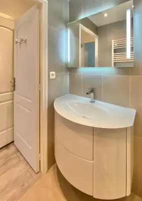 a bathroom with a white sink and a mirror at Budget studio Berlioz in Nice