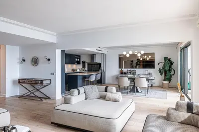 a living room with a couch and a kitchen at Superbe appartement Cap de nice in Nice