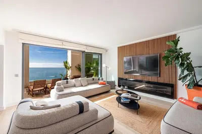 a living room with a couch and a tv at Superbe appartement Cap de nice in Nice
