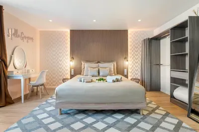 a bedroom with a large bed and a desk at Elegant Jacuzzi Loft in Central Massena in Nice