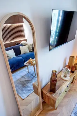 a living room with a stove and a mirror at Superbe studio Plage/ Promenade des Anglais 104 in Nice
