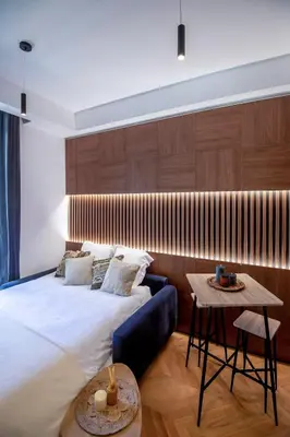 a living room with a table and a tv at Superbe studio Plage/ Promenade des Anglais 104 in Nice