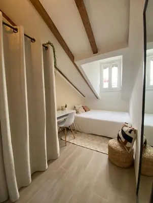 a attic bedroom with a bed and a bath tub at Lovely 1 Bedroom Apartment - Heart of Nice in Nice