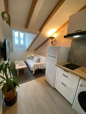 a kitchen with a white refrigerator and a couch at Lovely 1 Bedroom Apartment - Heart of Nice in Nice