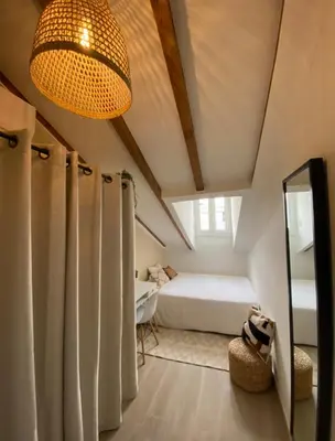 a bedroom with a bed and a mirror and a chandelier at Lovely 1 Bedroom Apartment - Heart of Nice in Nice