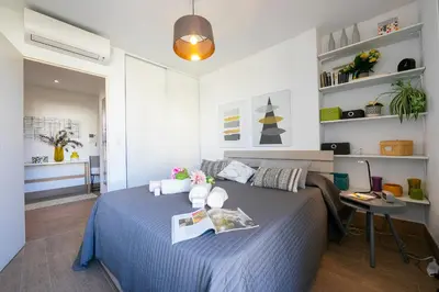 a bedroom with a blue bed in a room at Appartement Liberation in Nice